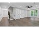 Open-concept living area with hardwood floors, staircase, and lots of natural light at 4657 Lou Ivy Rd, Peachtree Corners, GA 30096