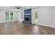 Spacious living room with hardwood floors, a blue stone fireplace, and bright, natural light at 4657 Lou Ivy Rd, Peachtree Corners, GA 30096