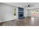 Bright living room features hardwood floors, a blue stone fireplace and views of the surrounding landscape at 4657 Lou Ivy Rd, Peachtree Corners, GA 30096