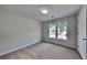 Cozy carpeted bedroom featuring double windows and a neutral color palette at 4954 Penscot Way, Stone Mountain, GA 30088