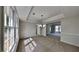 Bright dining room features large windows, neutral walls, plush carpet, and decorative tray ceiling at 4954 Penscot Way, Stone Mountain, GA 30088