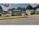 Charming two-story brick home with a manicured front lawn and attached two car garage at 4954 Penscot Way, Stone Mountain, GA 30088