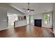 Open-concept living room with fireplace, wood floors, lots of light and access to kitchen at 4954 Penscot Way, Stone Mountain, GA 30088