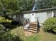 Back porch featuring stairs, railings, plants, and access to the main house at 6722 Heardsville Rd, Cumming, GA 30028