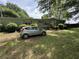 Home's exterior with a well-manicured lawn and mature trees at 6722 Heardsville Rd, Cumming, GA 30028