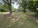 Single story home nestled among large trees in an open grassy lot at 6722 Heardsville Rd, Cumming, GA 30028