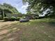 Home's exterior with large yard and mature trees at 6722 Heardsville Rd, Cumming, GA 30028