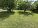 Spacious front yard with mature trees providing ample shade at 6722 Heardsville Rd, Cumming, GA 30028
