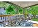 Relaxing front porch with wooden furniture and views of the surrounding greenery at 1149 Avondale Se Ave, Atlanta, GA 30312