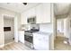 Galley kitchen with new stainless steel appliances and white cabinets at 1149 Avondale Se Ave, Atlanta, GA 30312