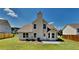 Well-maintained backyard boasts a full lawn and views of home's rear elevation at 5136 Estonian Dr, Fairburn, GA 30213