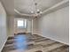 Bright dining room with tray ceiling, chandelier, and modern floors, perfect for entertaining at 5136 Estonian Dr, Fairburn, GA 30213