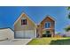 Charming two-story home features a stone facade, attached two-car garage, and well-maintained lawn at 5136 Estonian Dr, Fairburn, GA 30213