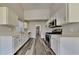 Modern kitchen with white cabinets, stainless steel appliances, and sleek countertops, ideal for cooking at 5136 Estonian Dr, Fairburn, GA 30213