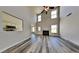 Spacious living room features soaring ceilings, a cozy fireplace, and stylish flooring throughout at 5136 Estonian Dr, Fairburn, GA 30213