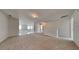 Open loft area featuring neutral carpet, bright light, and a staircase with white railings at 5136 Estonian Dr, Fairburn, GA 30213