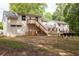 Home backyard featuring a deck with stairs, a firepit with seating, and lush greenery at 5322 Seaton Dr, Atlanta, GA 30338