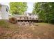 Expansive backyard with a fire pit, seating, deck, and lush green lawn at 5322 Seaton Dr, Atlanta, GA 30338
