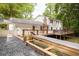 Expansive backyard view with large deck, stone path and flower beds in a lush, green setting at 5322 Seaton Dr, Atlanta, GA 30338