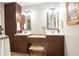 Bathroom boasts a vanity with double sinks, custom lighting, a tiled seat, and storage space at 5322 Seaton Dr, Atlanta, GA 30338