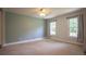 Bedroom featuring neutral walls, carpet, and natural light from two windows at 5322 Seaton Dr, Atlanta, GA 30338