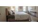A bedroom is bathed in natural light and contains neutral wall coloring, a bed, and decor at 5322 Seaton Dr, Atlanta, GA 30338