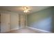 Bedroom with neutral carpet, light blue walls, and a closet with shelving at 5322 Seaton Dr, Atlanta, GA 30338
