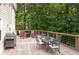 Outdoor wooden deck with a grill, dining table, and chairs for enjoying the backyard view at 5322 Seaton Dr, Atlanta, GA 30338