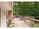 Spacious wooden deck perfect for outdoor entertaining with stylish patio furniture and a grill at 5322 Seaton Dr, Atlanta, GA 30338