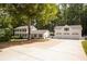 Traditional home featuring a three-car garage, neutral siding, dark shutters, and a spacious driveway at 5322 Seaton Dr, Atlanta, GA 30338