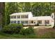 Charming two-story home featuring neutral siding, dark shutters and a well-maintained front yard at 5322 Seaton Dr, Atlanta, GA 30338