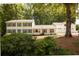 Traditional home featuring a three-car garage, neutral siding, dark shutters, and a well-maintained front yard at 5322 Seaton Dr, Atlanta, GA 30338