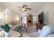 Cozy living room with hardwood floors, fireplace, ceiling fans, and wainscoting at 5322 Seaton Dr, Atlanta, GA 30338
