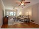 Cozy living room with hardwood floors, fireplace, ceiling fans, and wainscoting at 5322 Seaton Dr, Atlanta, GA 30338
