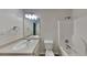 This bathroom features a white sink, toilet, bathtub, and a well-lit mirror at 700 Patriots Point St, Locust Grove, GA 30248