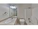This bathroom features a white sink, toilet, bathtub, and a well-lit mirror at 700 Patriots Point St, Locust Grove, GA 30248