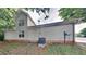 The back of a two-story home with beige siding and a well-maintained AC unit at 700 Patriots Point St, Locust Grove, GA 30248