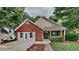 Charming single-story home featuring a brick facade, attached garage, and a welcoming front porch at 700 Patriots Point St, Locust Grove, GA 30248