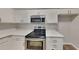 Modern kitchen featuring white cabinets, stainless steel appliances, and quartz countertops at 700 Patriots Point St, Locust Grove, GA 30248
