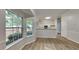 Bright living area featuring large windows, light wood floors, and an open layout towards the kitchen at 700 Patriots Point St, Locust Grove, GA 30248