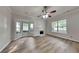 Inviting living room with a cozy fireplace, lots of natural light, and new light wood floors at 700 Patriots Point St, Locust Grove, GA 30248
