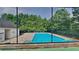 Community pool surrounded by a chain-link fence and lush trees, inviting relaxation at 700 Patriots Point St, Locust Grove, GA 30248