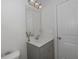 This bathroom features a gray vanity with a sink, a white countertop, and a decorative mirror at 126 Oakleigh Pointe Dr, Dallas, GA 30157