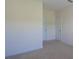 Bright bedroom features neutral carpet, white trim and two doors at 126 Oakleigh Pointe Dr, Dallas, GA 30157
