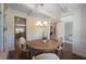 Elegant dining area with coffered ceiling and a round wooden table, adjacent to the staircase at 126 Oakleigh Pointe Dr, Dallas, GA 30157