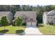 Charming two-story home featuring a well-manicured lawn, attached two car garage, and brick accents at 126 Oakleigh Pointe Dr, Dallas, GA 30157