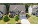 Charming two-story home featuring a well-manicured lawn, attached two car garage, and brick accents at 126 Oakleigh Pointe Dr, Dallas, GA 30157
