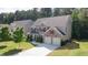 Charming two-story brick home with red shutters, well-manicured lawn, and a two-car garage at 126 Oakleigh Pointe Dr, Dallas, GA 30157