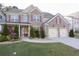 Inviting two-story brick house with red shutters, lush landscaping, and a well-maintained front yard at 126 Oakleigh Pointe Dr, Dallas, GA 30157