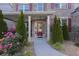 Inviting front porch with stone accents, lush landscaping, and a glass paneled front door at 126 Oakleigh Pointe Dr, Dallas, GA 30157